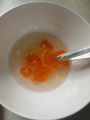 Heat the pan, add garlic, ginger, preserved egg and salted egg and stir-fry until fragrant