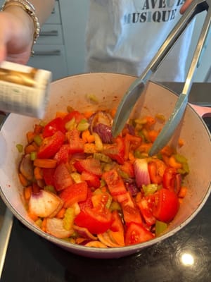 After that, add in the chopped tomatoes, and add in black pepper and salt to soften the vegetables