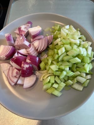 Hacher l'oignon, le céleri, les tomates et les carottes comme indiqué