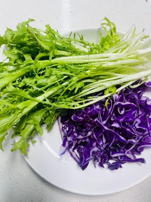 생고기와 익힌 재료 사이의 교차 오염을 방지하기 위해 생고기 전용 도마를 사용하여 보라색 양배추를 잘게 채 썰어주세요. 엔다이브는 깨끗이 씻은 후 키친타월로 가볍게 두드려 물기를 제거해주세요. 이렇게 하면 스프링롤 wrappers가 습기를 머금어 말 때 찢어지는 것을 방지할 수 있습니다.