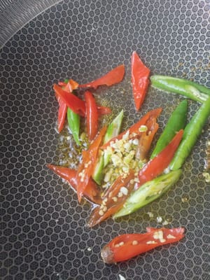 Pour some oil into the green and red peppers, ginger and garlic and fry until fragrant, then pour in the sauce.