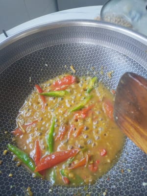When the ingredients turn yellow and start to bubble, add the reserved eggplant and stir-fry together.