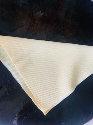 3. 由於我沒買到豆腐結，我買了千張嚟代替。每張千張長30cm，我把它分成兩半，對折後從頂角開始捲起嚟，然後打結。要是它“不聽話”，打不結實，就用牙籤紮它😀。當然，你也可以直接買現成打好結的豆腐結。
