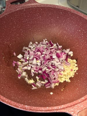 In the same pan, fry diced onion and garlic