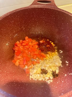 En otro hoyo, sofreír el ajo, el jengibre, el tomate, el anís estrellado y la pasta de frijoles picante hasta que estén aromáticos.