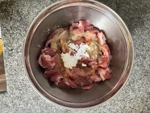 豬肉切片，加入調味料（油，豉油，鹽，糖和薯仔澱粉）