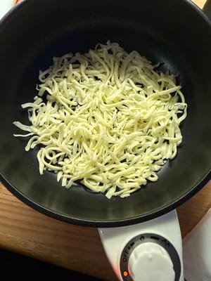 Add cheese to a cold pan and cook on low heat