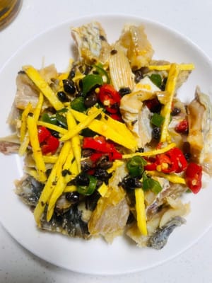 お皿を用意し、まず豚バラ肉を下に敷き、その上にマリネした魚を並べます。最後にマリネ液と生姜のスライスを注ぎます。香りを一滴も逃がさないように。