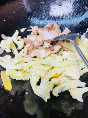 加之前炒好的五花肉，往锅边拨。锅底加一勺干锅酱炒香，放入红彩椒、大葱、葱段炒至断生，翻炒均匀装在喜欢的餐具上。若家人不吃辣，放干锅酱前铲出部分食材备用。
