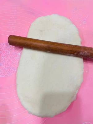 擀面皮
把要做面包大土司的面团拿出来,擀成长长薄薄的面皮,差不多宽20cm,长30cm左右,擀的时候要是有大气泡,就用手轻轻拍掉。