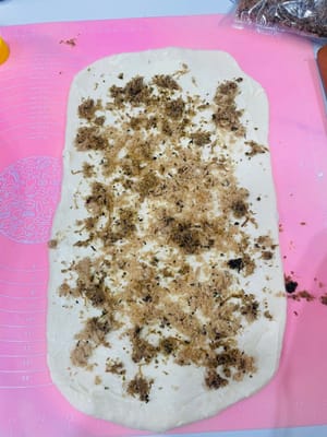 涂酱撒料
在擀好的面皮上涂上沙拉酱,撒上肉松和葱花,喜欢芝士的还能撒点芝士碎,跟做披萨铺料似的。