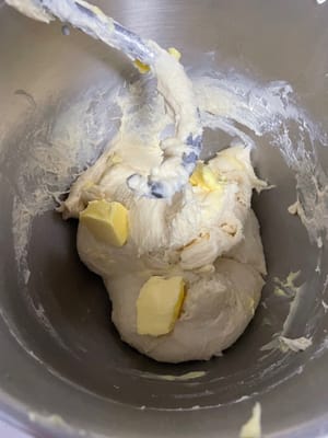 Now add the butter and continue kneading until it forms a thin, elastic membrane (like a glove). The membrane should be thin and resilient, with smooth edges when torn.