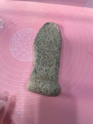 Take a rested dough ball, gently flatten it to release the air, roll it out into a long strip with a rolling pin, and roll it up; roll it out again, roll it up again, and place it vertically into a loaf pan.

Repeat this process for all three loaves, placing them one by one into the loaf pan.