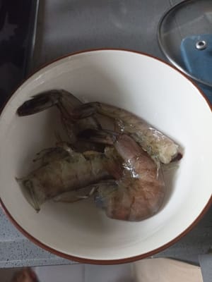 Lavar y retirar las cabezas de los camarones.