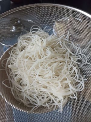 Colamos los fideos y luego los enjuagamos con agua caliente.