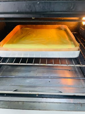 予熱したオーブンの真ん中の段でケーキ生地を20分焼きます（表面が焦げて苦味が出ないように、約13分後にアルミホイルで覆ってください）。オーブンによって焼き加減が異なるため、焼き加減を調整してください。