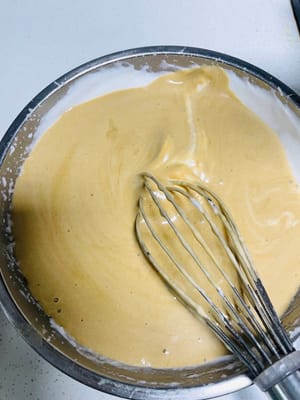 Pour the remaining egg whites into the batter and continue to stir in an