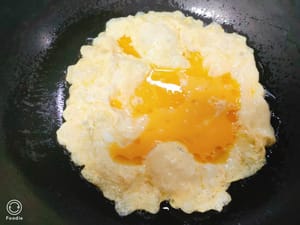 Heat oil in a pan and pour in two eggs.