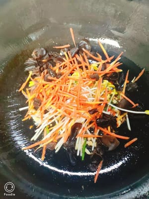 Add 30g bean sprouts, 50g carrots, and 10g fungus. Stir-fry until they are broken.