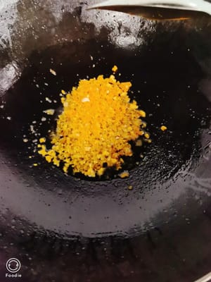 Tambahkan kuning telur asin yang telah dicincang ke dalam panci berisi minyak yang sama dan tumis terus-menerus dengan api kecil hingga panci penuh dengan busa. Setelah mencapai tahap ini, tambahkan semangkuk air mendidih (sekitar 200 ml).