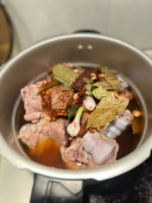加入所有香料和醬汁，以及兩罐啤酒。再加入滾水，淹沒所有食材。壓力煲煮20分鐘，普通鍋煮1.5小時。