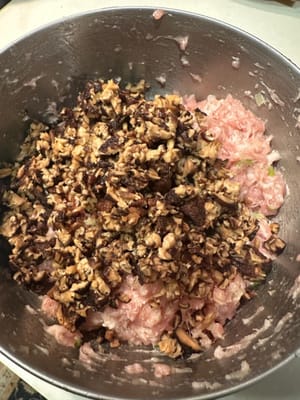 將蘑菇放入研磨機中研磨成泥，然後加入豬肉末中。