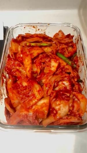 Zum Schluss das Kimchi in sterilisierte Behälter füllen und einen Tag lang bei Zimmertemperatur fermentieren lassen. Anschließend im Kühlschrank aufbewahren und nach Belieben servieren. Guten Appetit!