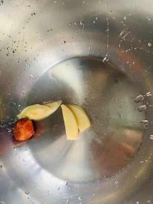 Add ginger slices, candied dates, soybeans, and bones into the pressure cooker. Ginger slices can remove the fishy smell and enhance the flavor, while candied dates can balance the bitterness of bitter melon.
