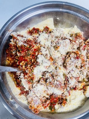 Add 50 grams of salt to the three ground powders, mix well, then add the crushed chili peppers. Wearing gloves, mix by hand until fully combined. The flavor should be slightly saltier than usual.