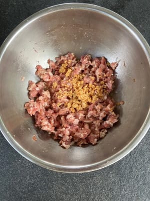 Add fried garlic to the pork and mix.