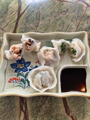 On the top left is fungus dumpling and the top right is chive dumpling. Aged Chinese black vinegar goes well with the dumplings.