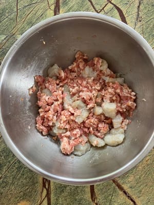 Add shrimp to the pork and mix.