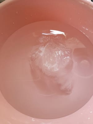 Prepare a bowl filled with water and ice cubes. Press the dough into a perforated container right in the bowl of ice water (press the dough while it is still hot). Do this until the dough is finished. Once it is done, set it aside.