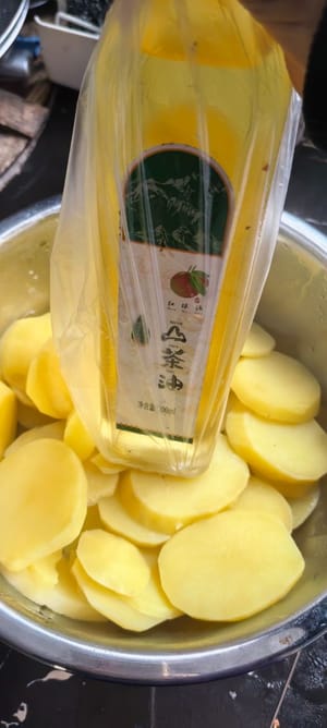 Pour the steamed potatoes into a container, cover them with a plastic wrap, and press them until they are soft and tender.