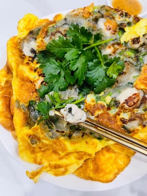 Setelah minyak mencapai suhu yang diinginkan, masukkan setengah pasta tiram (saya menggunakan dua porsi). Kecilkan api menjadi sedang-rendah dan goreng hingga bagian bawah berwarna cokelat keemasan, balikkan. Kemudian, tambahkan campuran telur dan lanjutkan menggoreng dengan api sedang-rendah, sambil memantau tiram. Setelah tiram mengembang dan berwarna cokelat keemasan di kedua sisi (tanpa sisa pasta putih yang belum matang), sajikan dan hiasi dengan daun ketumbar yang telah disiapkan.
Jika Anda lebih suka tekstur yang lebih renyah, Anda bisa menggorengnya lebih lama, tetapi hati-hati jangan sampai terlalu matang, karena bisa mengering atau menjadi keras.