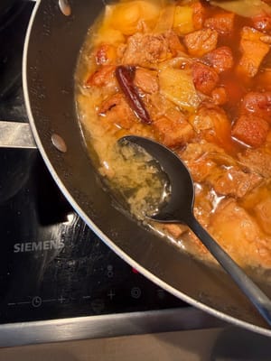 After one hour, skim off half of the oil from the side of the pan.