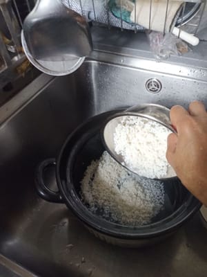 Waschen Sie den Behälter und geben Sie den Reis hinein. Ich schütte das Wasser, in dem ich den Reis eingeweicht habe, nicht weg, Freunde, also behalte ich es zum Kochen.