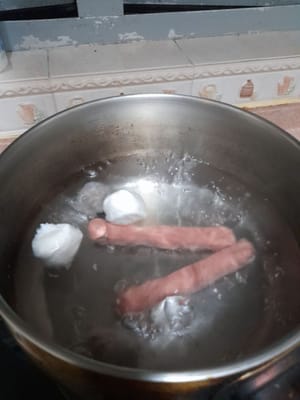 Se pone a hervir el agua, luego se agregan las salchichas, las albóndigas de res, las albóndigas de pescado que han sido lavadas bien, se hierven hasta que estén cocidas durante ±10 minutos.
